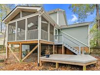 Lovely screened porch featuring skylights and wooden deck, perfect for outdoor relaxation and entertaining at 4117 Olde Coach Rd, Durham, NC 27707
