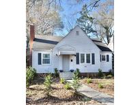 Charming single Gathering home with a brick chimney, inviting front yard, and tasteful landscaping at 517 E Club Blvd, Durham, NC 27704