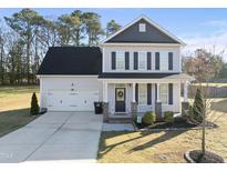 Charming two-story home with a well-manicured lawn and inviting front porch at 54 Silverleaf Dr, Wendell, NC 27591