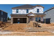 New construction home features a brick facade, attached garage, and unfinished front yard at 571 White Birch Ln, Angier, NC 27501