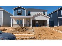 Two-story home with blue and white siding, covered porch, and attached two-car garage in the process of being completed at 591 White Birch Ln, Angier, NC 27501
