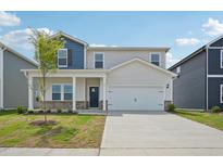 Charming two-story home featuring a covered front porch and a two-car garage at 591 White Birch Ln, Angier, NC 27501