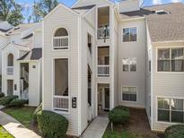 Exterior of a multi-level condo building with balconies and well-maintained landscaping at 6001 Winterpointe Ln # 204, Raleigh, NC 27606