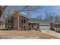 Charming brick home with a two-car garage, landscaped yard, and classic blue front door, perfect for a Gathering at 6089 Joe Trail Ct, Mebane, NC 27302