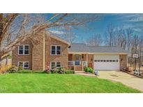 Charming brick home featuring a well-manicured lawn and an attached two car garage at 6089 Joe Trail Ct, Mebane, NC 27302