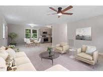 Open-concept living room featuring modern furnishings and decor with a smooth transition to the dining area and kitchen at 610 Pineland St, Sanford, NC 27330