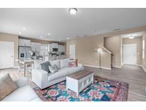 Bright living room featuring an open layout with a modern white sofa and a colorful rug at 656 Dallas Rose Dr, Wendell, NC 27591