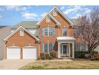 Beautiful two-story brick home with attached two car garage and manicured lawn, perfect for families at 7533 Silver View Ln, Raleigh, NC 27613
