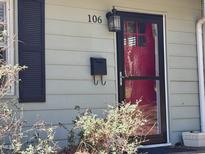 Charming home featuring a stylish black-framed screen door and mailbox with a vibrant red front door at 106 Eugene St, Carrboro, NC 27510