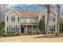 Traditional two-story home with a manicured lawn, neutral siding, and black shutters for a classic curb appeal at 116 Galway Dr, Chapel Hill, NC 27517