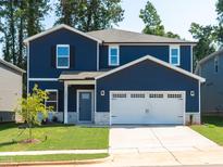 Charming two-story home featuring a spacious two-car garage and beautifully landscaped front yard at 153 Klamath Dr, Garner, NC 27529