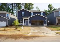 Charming two-story home with a spacious two-car garage and a well-manicured front yard at 153 Klamath Dr, Garner, NC 27529