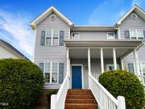 Charming home with a blue front door, brick steps, and mature landscaping at 2013 Turtle Point Dr, Raleigh, NC 27604