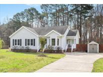 Charming single-story home with light siding, black shutters, and a well-manicured lawn at 236 Bowling Farm Ct, Raleigh, NC 27603