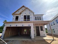 Exterior of a new two-story home under construction featuring a two-car garage and a covered front porch at 243 Meadowbark Bnd # 28, Garner, NC 27529