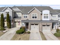 Charming townhouse with attached garages, neutral siding, and manicured landscaping at 2821 Casona Way, Raleigh, NC 27616