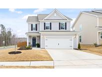 Charming two-story home with light gray siding, black shutters, and a two-car garage at 3103 Woodland Park Rd, Durham, NC 27703