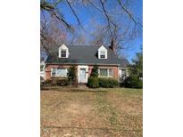 Charming brick home featuring a well-maintained front yard and classic architectural details at 333 Leasburg Rd, Roxboro, NC 27573