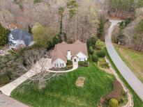 A charming home with well-manicured lawn and a quaint garden surrounded by lovely trees at 5300 Mandrake Ct, Raleigh, NC 27613