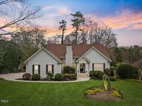 Inviting one-story home with manicured lawn and mature landscaping in a suburban setting at 5300 Mandrake Ct, Raleigh, NC 27613