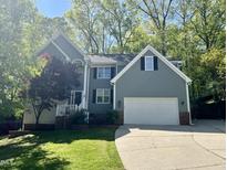 Charming two-story home with an attached two-car garage and a well-manicured lawn at 6008 Chittim Ct, Raleigh, NC 27616