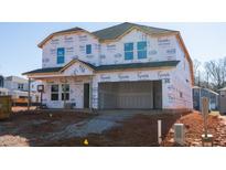 Exterior framing and wrapping of a two-story new construction home in a suburban neighborhood setting at 701 Deschutes Dr, Garner, NC 27529