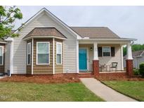 Charming single-story home featuring a covered front porch, bay window, and well-manicured lawn at 75 E Moss Creek Dr, Clayton, NC 27520