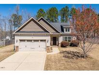 Charming home featuring a well-manicured lawn, attached garage, and neutral color palette at 96 Foxtail Ct, Clayton, NC 27520