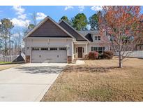 Charming home featuring a two-car garage and well-manicured front lawn at 96 Foxtail Ct, Clayton, NC 27520