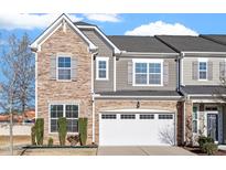 Charming townhome with a stone facade, two-car garage, and beautifully manicured front yard at 1029 Benay Rd, Morrisville, NC 27560