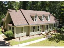 Charming single-story home with light green siding, a new roof, and dormer windows at 1116 Shadywood Ln, Raleigh, NC 27603