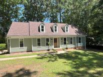 Charming single-story home with dormer windows and a well-manicured lawn surrounded by mature trees at 1116 Shadywood Ln, Raleigh, NC 27603