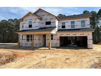 Exterior of new construction home under construction shows the house wrap, windows, and garage at 114 Tee Time Ter, Benson, NC 27504