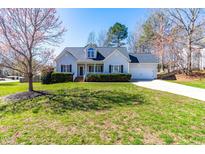 Charming one-story home with manicured lawn, attached garage, and inviting front porch at 136 Mayflower Way, Clayton, NC 27527