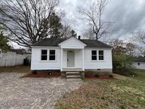 Charming, newly renovated single-story home with a well-maintained lawn and neutral color scheme at 1405 Parham St, Henderson, NC 27536