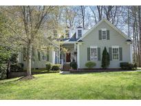 Charming home with a well-manicured lawn, complemented by decorative shutters and tasteful landscaping at 1705 Mcrae Pl, Hillsborough, NC 27278