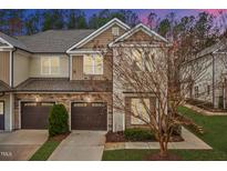 Charming townhome featuring stone accents, a private garage, and beautifully landscaped surroundings at 200 Mariah Towns Way, Garner, NC 27529
