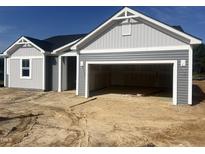 Gray two-car garage home exterior featuring blue sky, light siding, and dark roof at 207 Golfview Ave, Benson, NC 27504