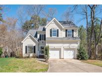 Charming two-story home with a manicured lawn and a two-car garage at 2100 Summit Dr, Hillsborough, NC 27278