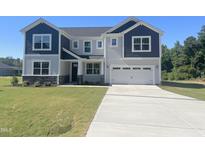Two-story home with a gray and navy exterior, two-car garage, and a well-manicured front lawn at 245 Golfview Ave, Benson, NC 27504