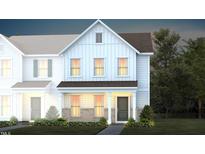 Charming two-story home with board and batten siding, a welcoming front porch, and lush landscaping at 373 Fosterton Cottage Way, Raleigh, NC 27603