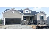 Charming, single-Gathering home with a two-car garage, craftsman details, and stone accents in a construction zone at 47 Tee Time Ter, Benson, NC 27504