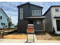 Modern two-story home with dark siding, white trim, and a brick foundation at 50 Rainfall Dr, Pittsboro, NC 27312