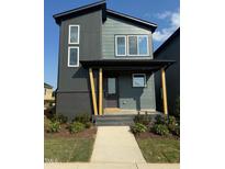 Two-story home with modern design, gray siding, and a covered front porch with wooden support beams at 50 Rainfall Dr, Pittsboro, NC 27312