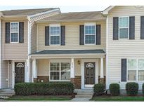 Charming two-story home with stone accents, gray shutters and landscaped yard at 5210 Blue Lagoon Ln, Raleigh, NC 27610