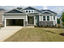Charming craftsman-style home with a two-car garage, stone accents, and a well-manicured lawn at 63 Tee Time Ter, Benson, NC 27504