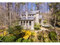 Beautiful home with multiple windows surrounded by lush trees at 7409 Birch Tree Ln, Wake Forest, NC 27587