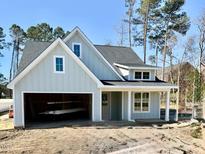 Charming new construction home with light siding, white trim, garage and covered entryway at 8487 Old Us 421, Lillington, NC 27546