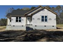 New construction home exterior featuring a white front door, grey shingles, and block foundation at 9600 Stallings Rd, Spring Hope, NC 27882
