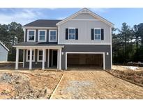 Two-story home featuring gray siding, white trim, covered porch, and an attached two car garage at 98 Tee Time Ter, Benson, NC 27504